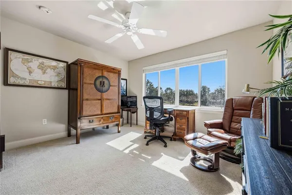 a living room with furniture gym equipment and a large window