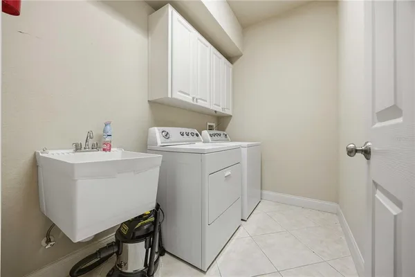a utility room with sink dryer and washer