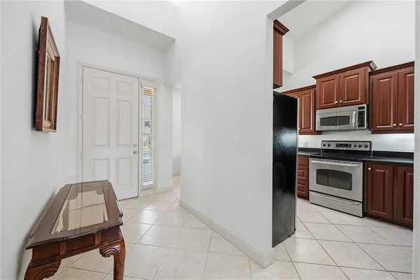 a kitchen with granite countertop a stove and a refrigerator
