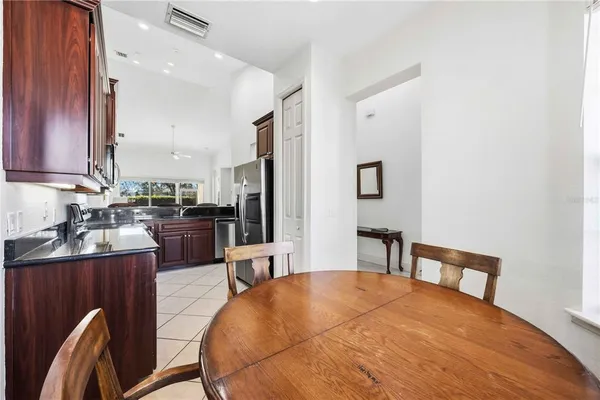 a kitchen with stainless steel appliances kitchen island granite countertop a sink refrigerator and cabinets