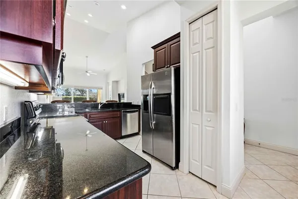 a kitchen with stainless steel appliances granite countertop a refrigerator and a sink