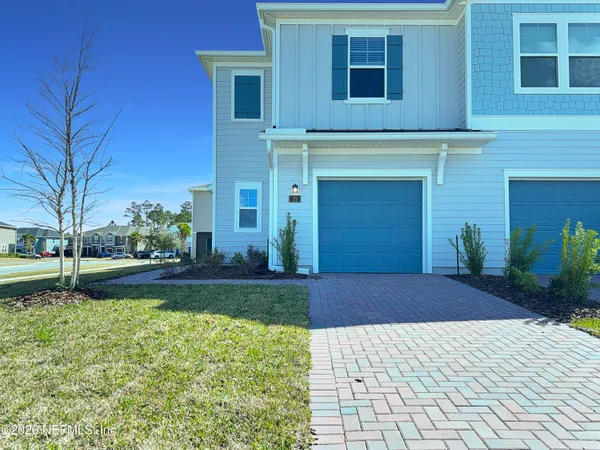 a kitchen with stainless steel appliances granite countertop a refrigerator a sink a stove and white cabinets