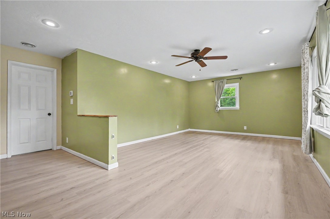 952 Ravenna Road Kent, OH 44240 - Photo 10 of 37 Spacious great room area with large window, ceiling fan and recessed lighting.