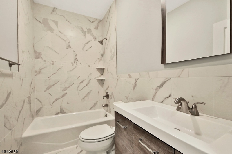 115 Watchung Avenue, Unit 1 Montclair, NJ 07043 - Photo 15 of 15 a bathroom with a sink toilet and shower