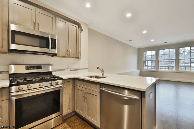 115 Watchung Avenue, Unit 1 Montclair, NJ 07043 - Photo 8 of 15 a kitchen with stainless steel appliances granite countertop a stove microwave and sink