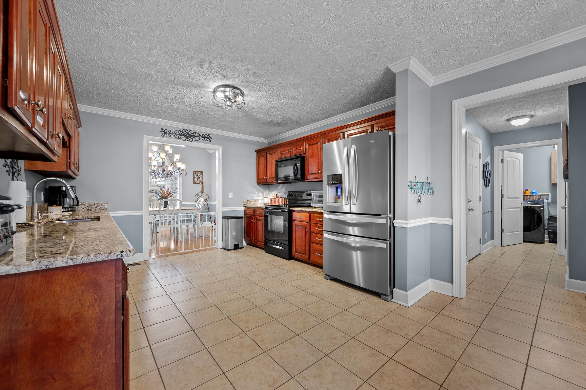 201 Oak Hollow Road Manchester, TN 37355 - Photo 16 of 43 a kitchen with stainless steel appliances granite countertop a refrigerator oven a sink dishwasher and white cabinets with wooden floor