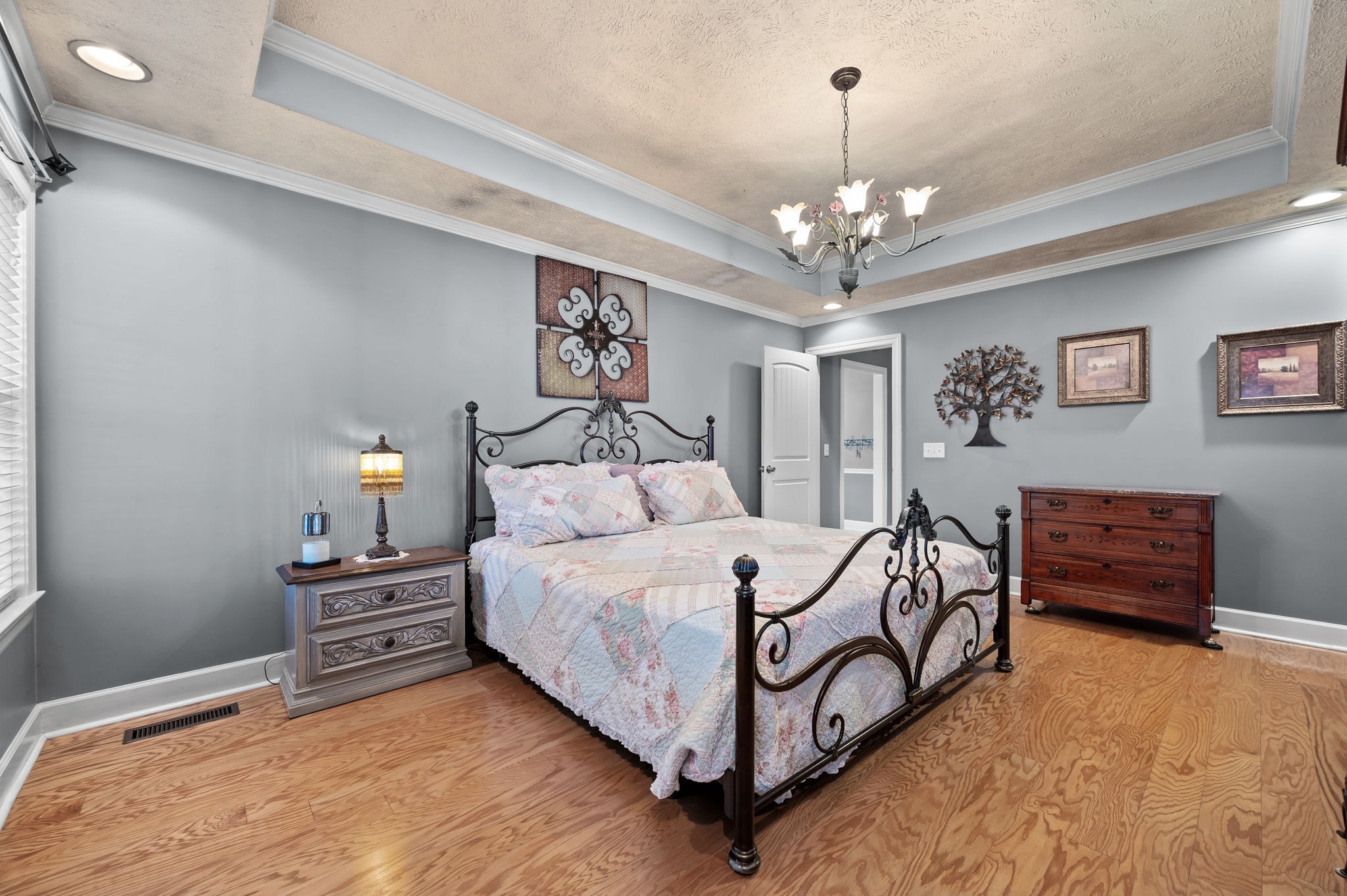 201 Oak Hollow Road Manchester, TN 37355 - Photo 19 of 43 a bedroom with a bed and a chandelier