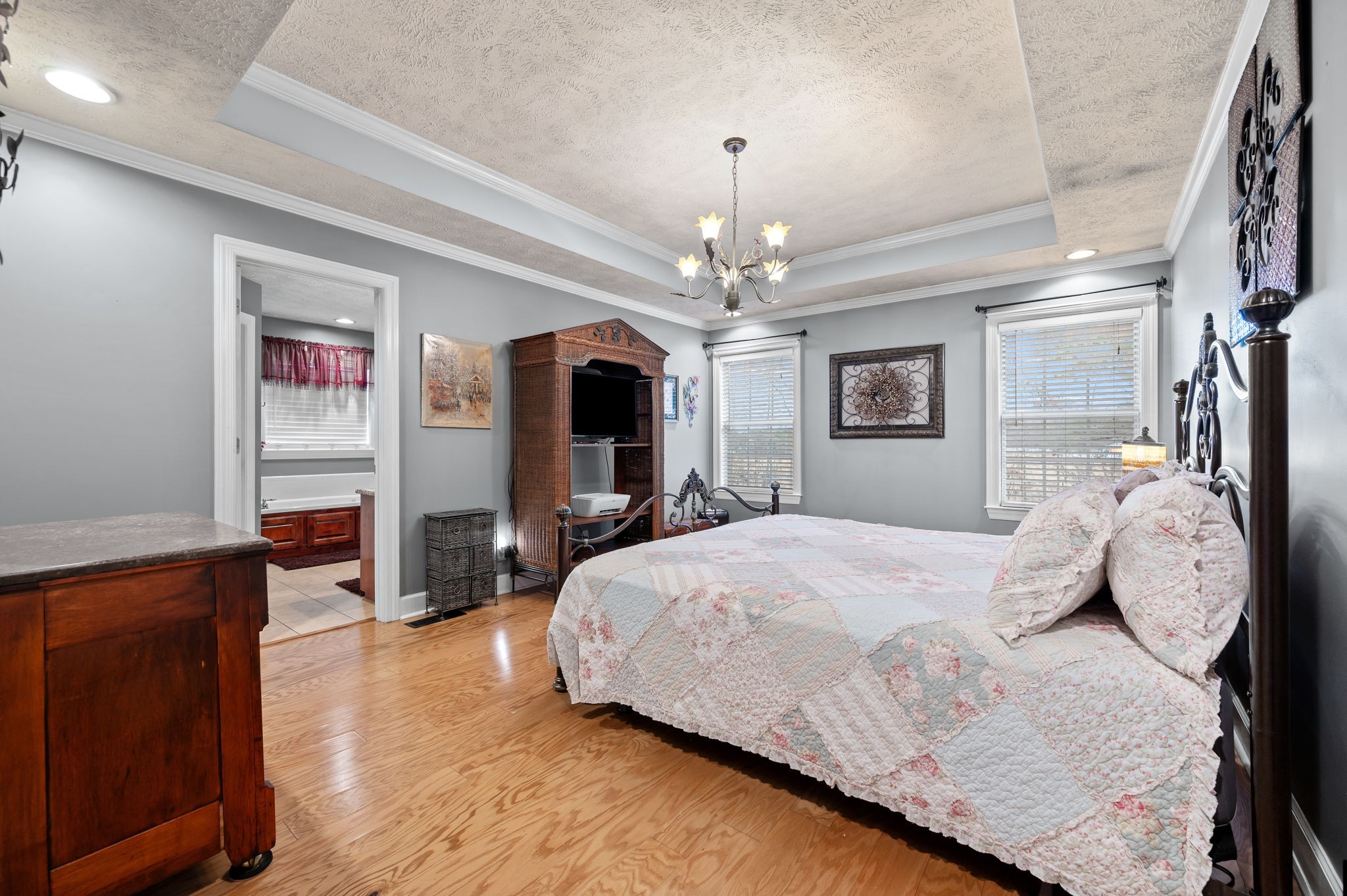 201 Oak Hollow Road Manchester, TN 37355 - Photo 20 of 43 a spacious bedroom with a large bed and a chandelier