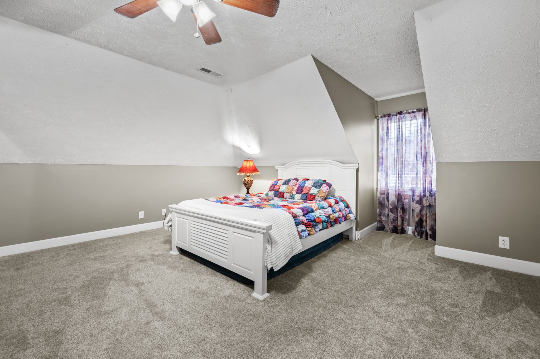 201 Oak Hollow Road Manchester, TN 37355 - Photo 28 of 43 a bed sitting in a bedroom next to a lamp