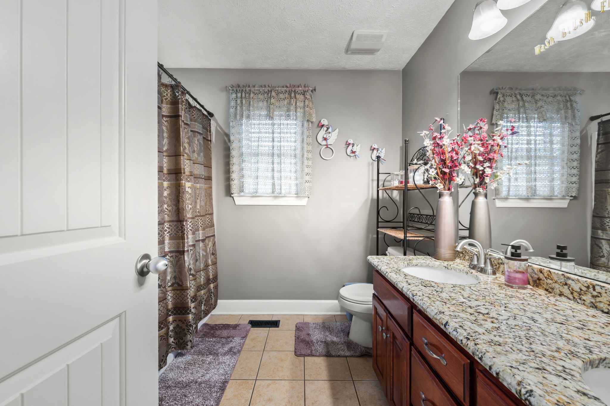 201 Oak Hollow Road Manchester, TN 37355 - Photo 8 of 43 a bathroom with a granite countertop sink a toilet and shower