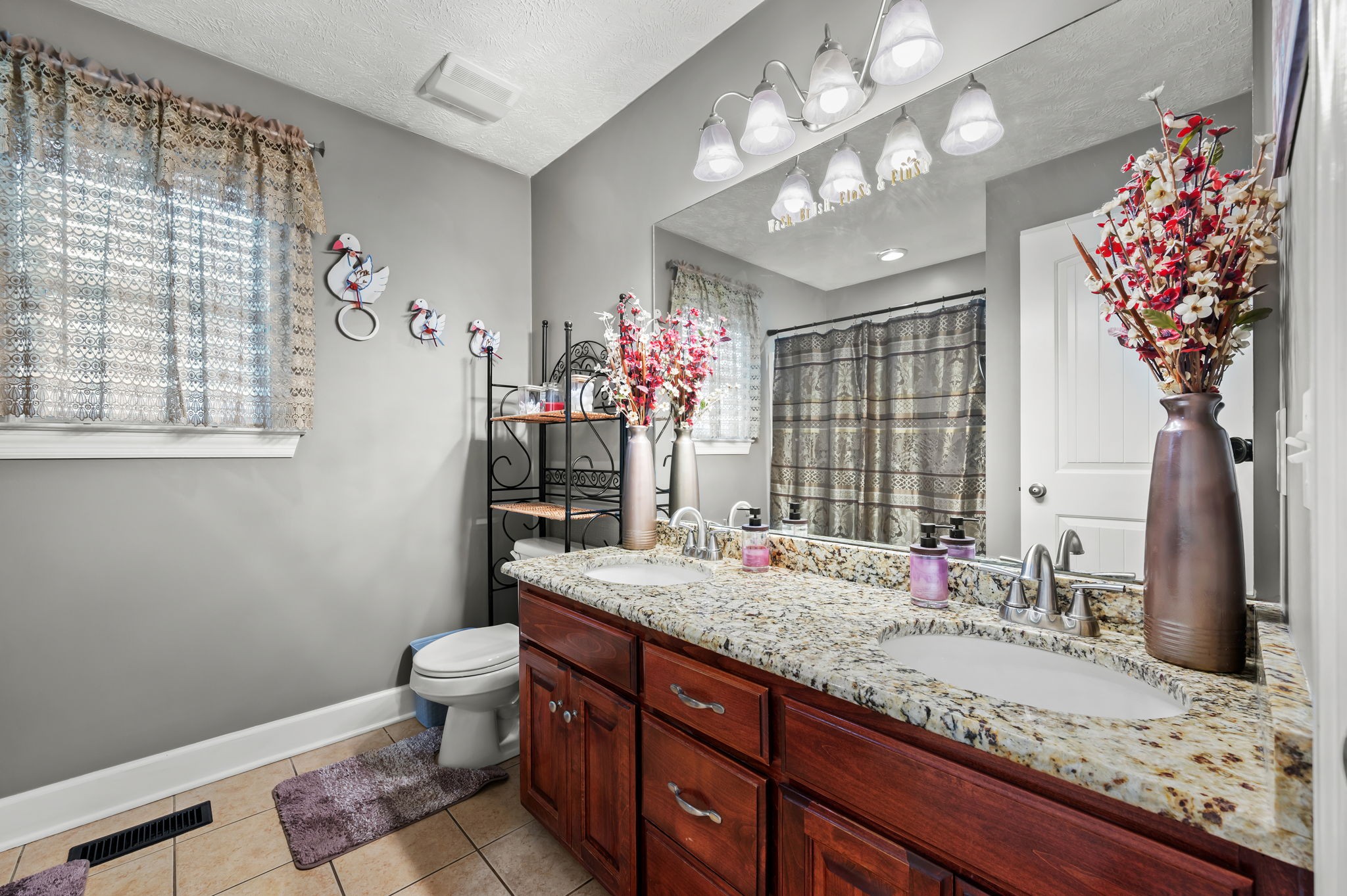201 Oak Hollow Road Manchester, TN 37355 - Photo 9 of 43 a bathroom with a granite countertop sink a large mirror and a shower