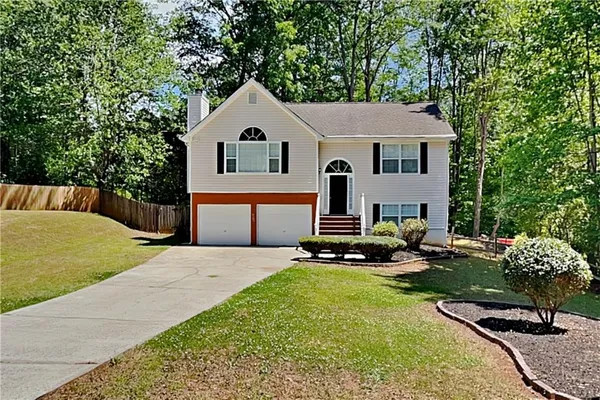 a front view of a house with a yard