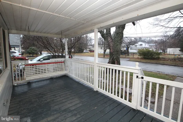 a view of a room with wooden floor and iron stairs