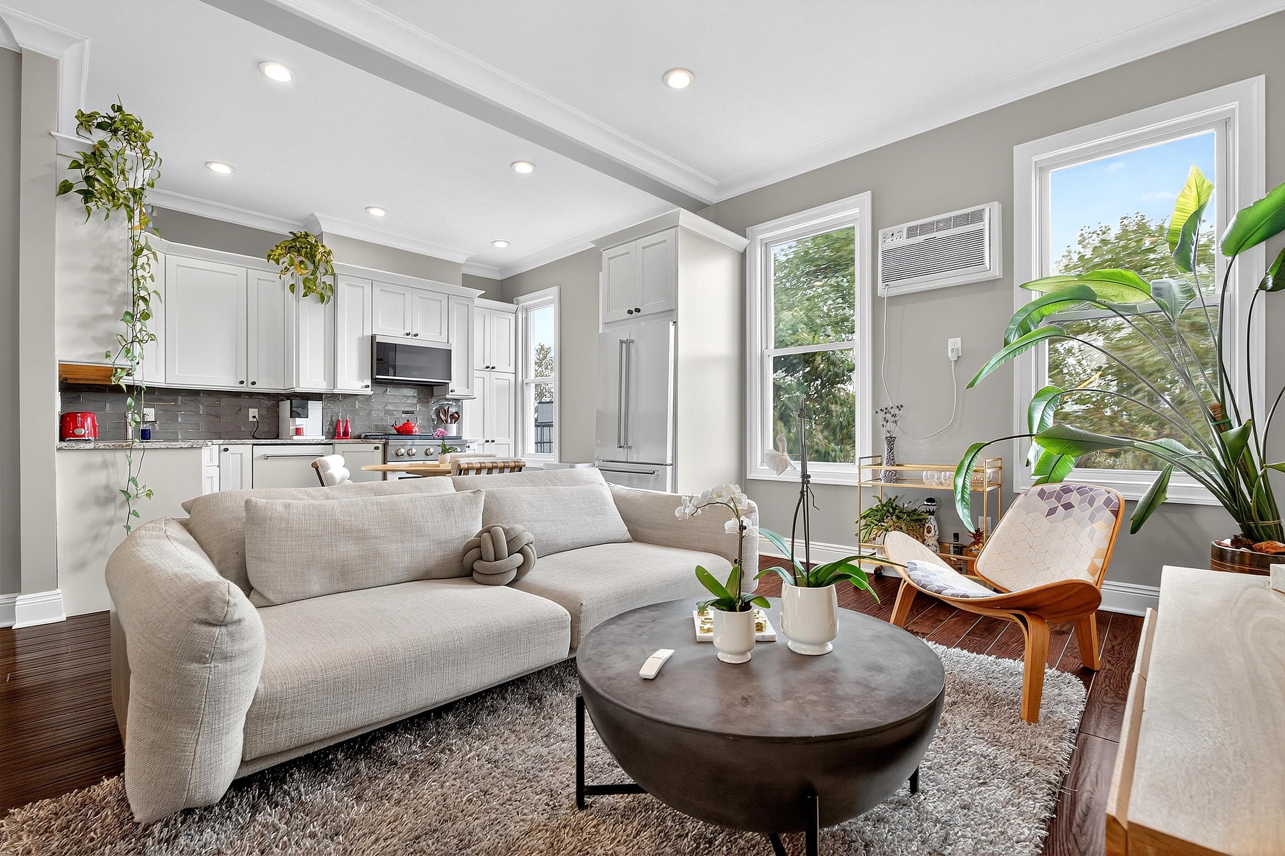 129 Prospect Street, Unit 3 Jersey City, NJ 07307 - Photo 1 of 34 a living room with furniture and a large window