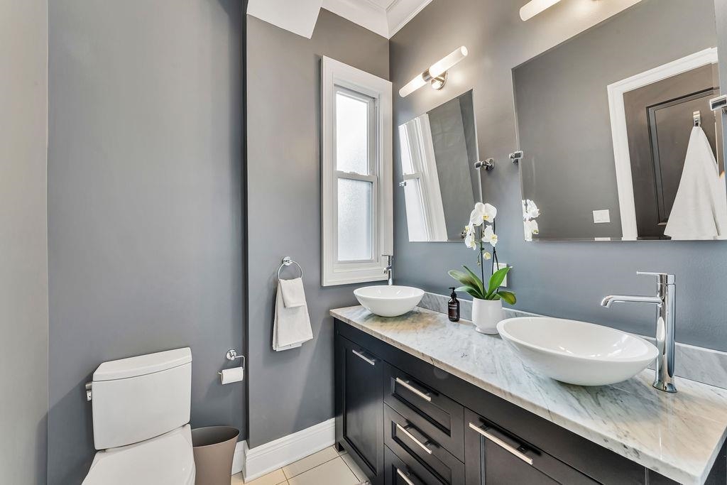 129 Prospect Street, Unit 3 Jersey City, NJ 07307 - Photo 15 of 34 a bathroom with a granite countertop sink and a mirror