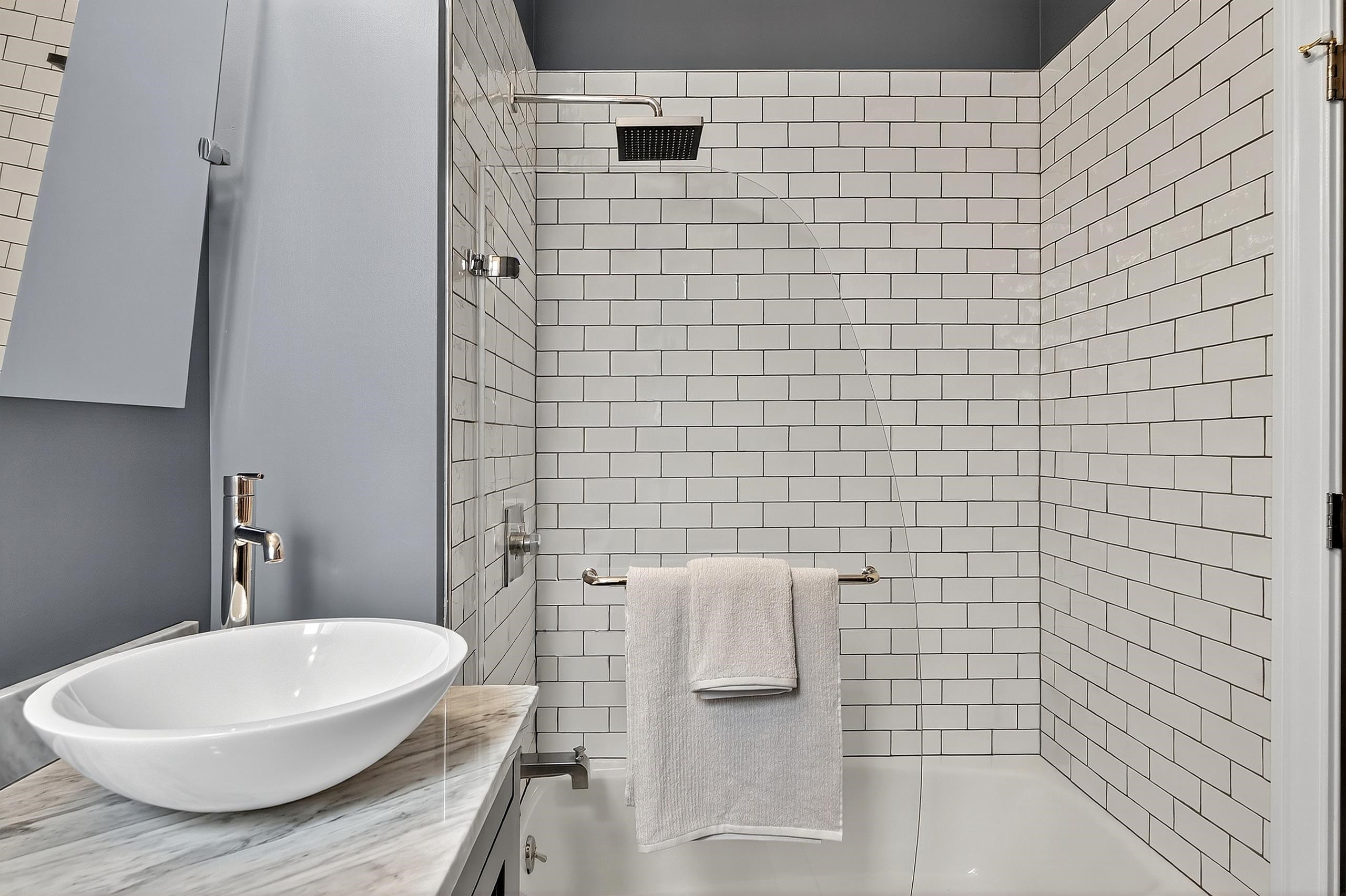 129 Prospect Street, Unit 3 Jersey City, NJ 07307 - Photo 17 of 34 a bathroom with a bathtub and shower