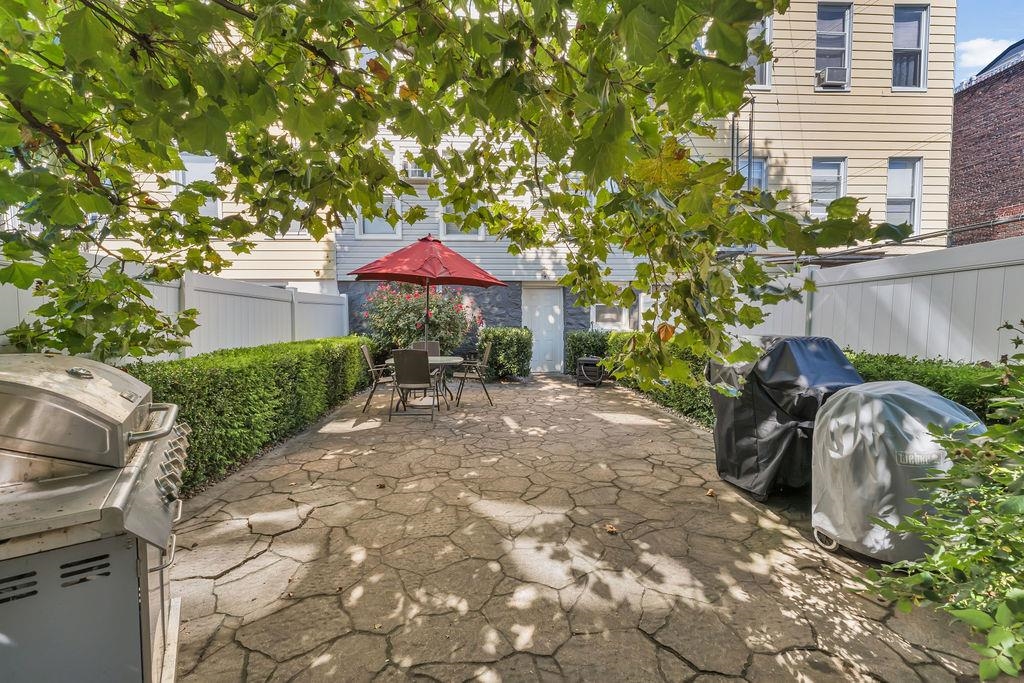 129 Prospect Street, Unit 3 Jersey City, NJ 07307 - Photo 30 of 34 a view of a backyard with plants and a patio