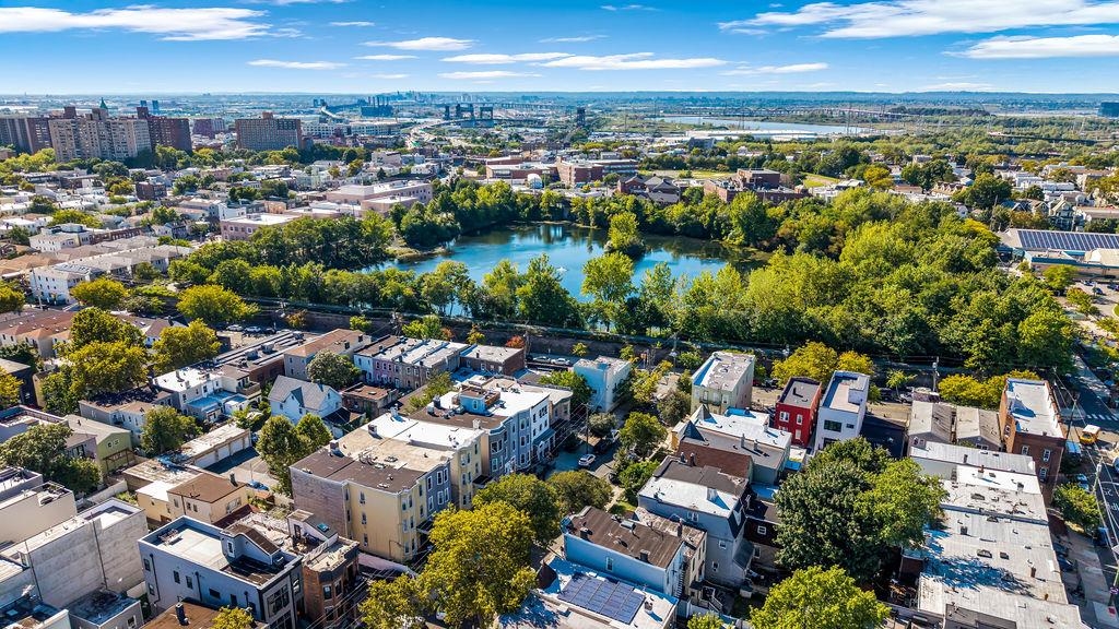 129 Prospect Street, Unit 3 Jersey City, NJ 07307 - Photo 33 of 34 an aerial view of a city with lots of residential buildings and ocean view in back