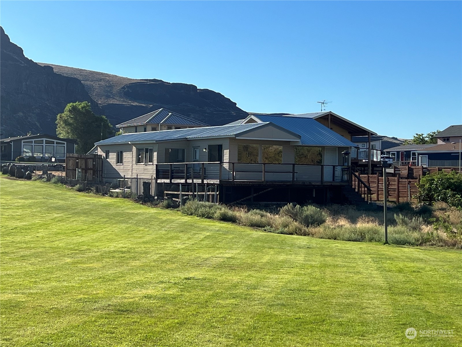 a view of a house with swimming pool and a yard