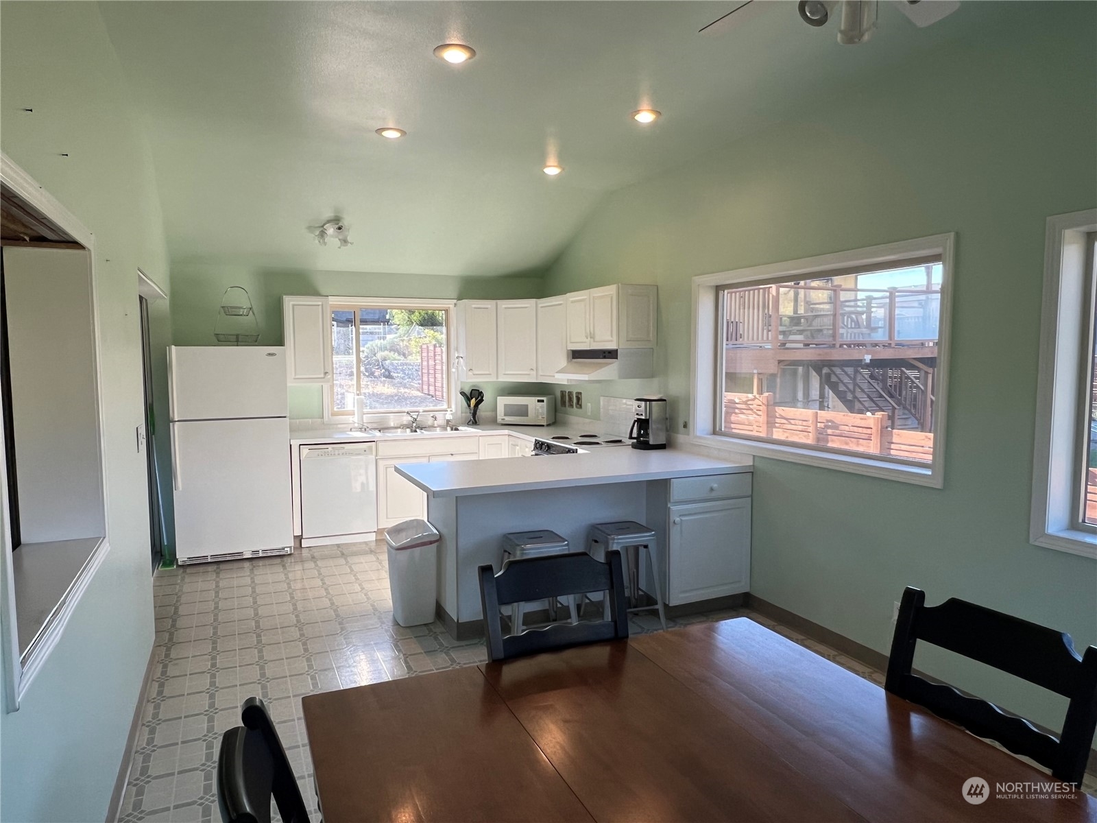 910 River Drive Quincy, WA 98848 - Photo 6 of 15 a kitchen with kitchen island a dining table chairs refrigerator and cabinets