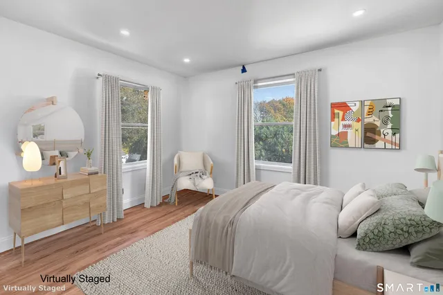 a bedroom with a large bed and a window