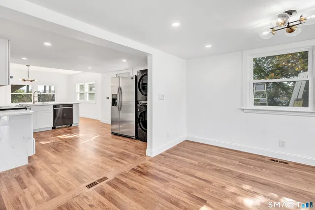 a view of a kitchen with a sink and a refrigerator