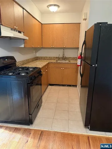 a kitchen with stainless steel appliances granite countertop a refrigerator and a stove