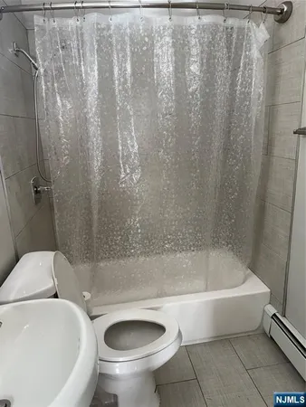 a bathroom with a toilet and a bathtub
