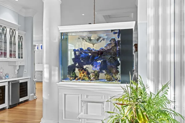 a bathroom with a granite countertop sink a large mirror and a window