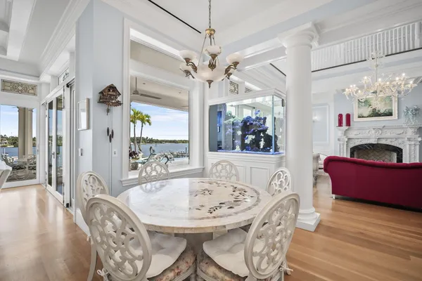 a view of a hallway with wooden floor and a living room