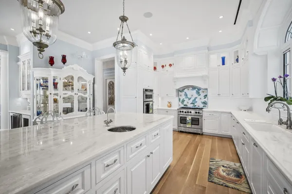 a bedroom with a bed and a chandelier