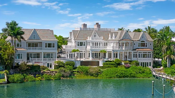 an aerial view of a house with yard garage and a patio