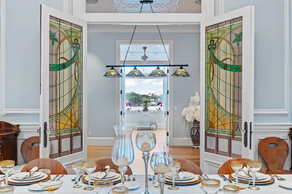 a living room with furniture a flat screen tv and a floor to ceiling window