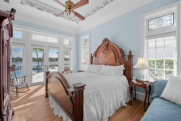 a bedroom with a bed and a painting on the wall