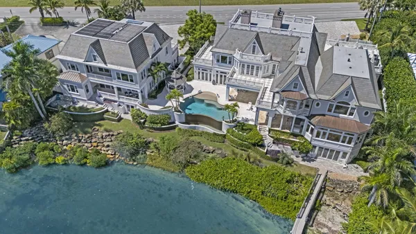 a living room with furniture a chandelier and a fireplace