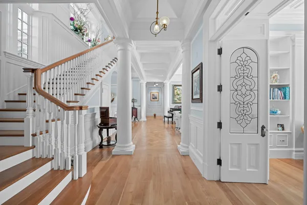 a view of entryway with wooden floor and stairs