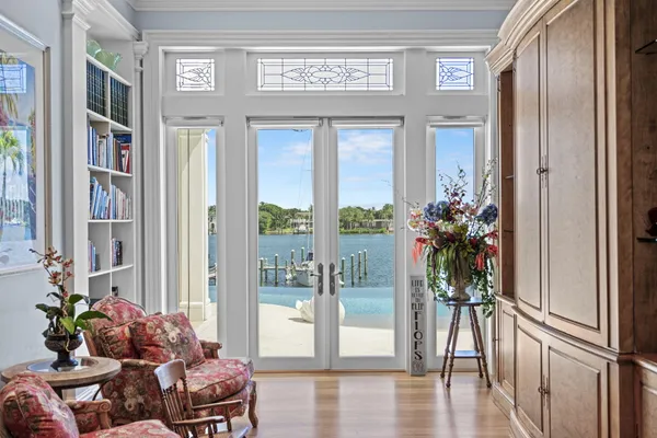 a work room with large window and a wooden floor