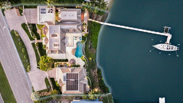 a kitchen with granite countertop white cabinets and stainless steel appliances