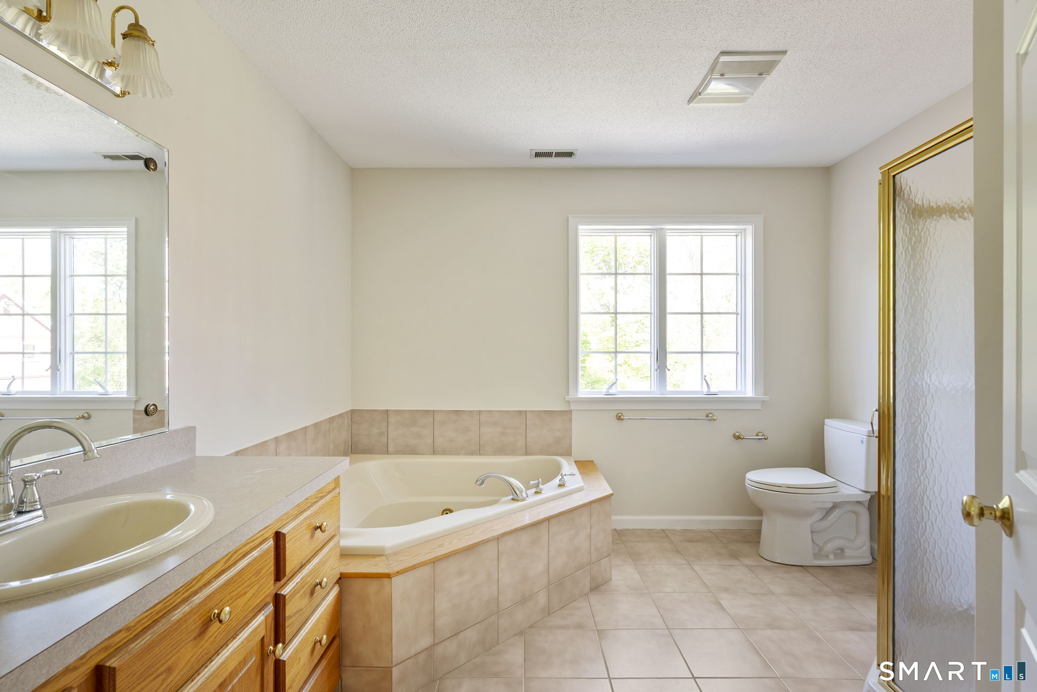 555 Waterville Road Avon, CT 06001 - Photo 32 of 40 a bathroom with a granite countertop sink and a bathtub