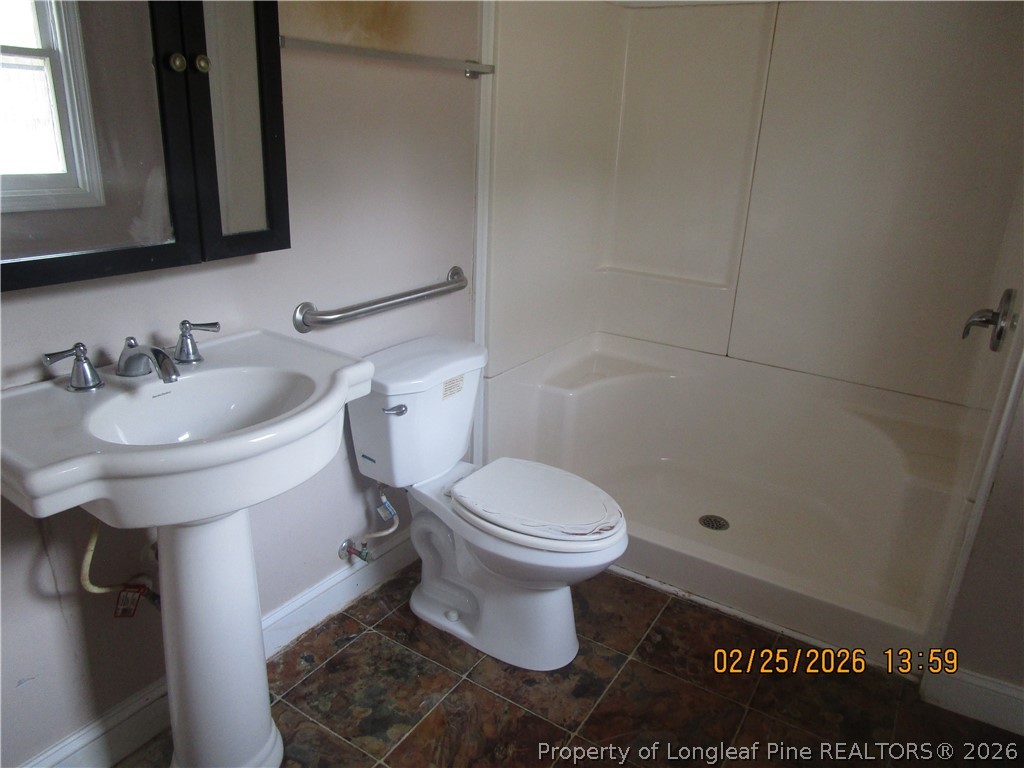 256 Chesters Road Roseboro, NC 28382 - Photo 21 of 22 a bathroom with a sink toilet and mirror