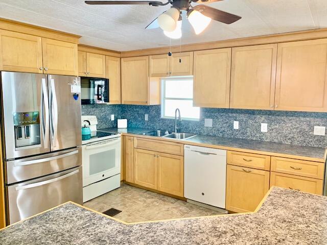 808 South Silver Circle Key Largo, FL 33037 - Photo 14 of 50 a kitchen with stainless steel appliances granite countertop a sink a stove and refrigerator