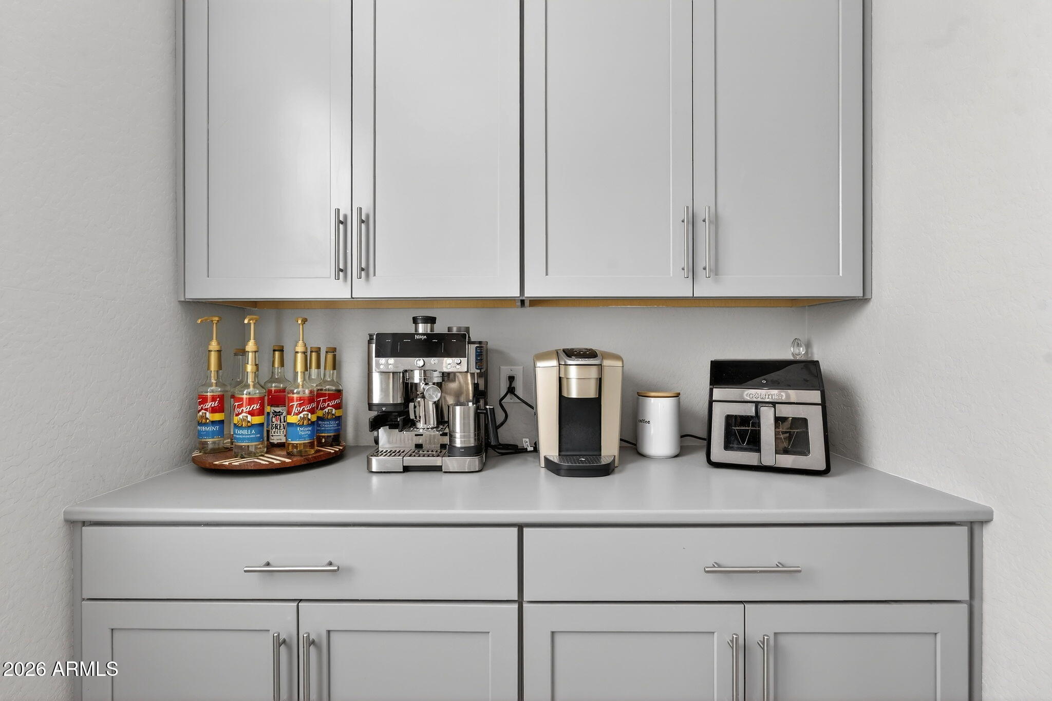 1663 West Gordon Street San Tan Valley, AZ 85144 - Photo 18 of 54 a kitchen with white cabinets and white appliances