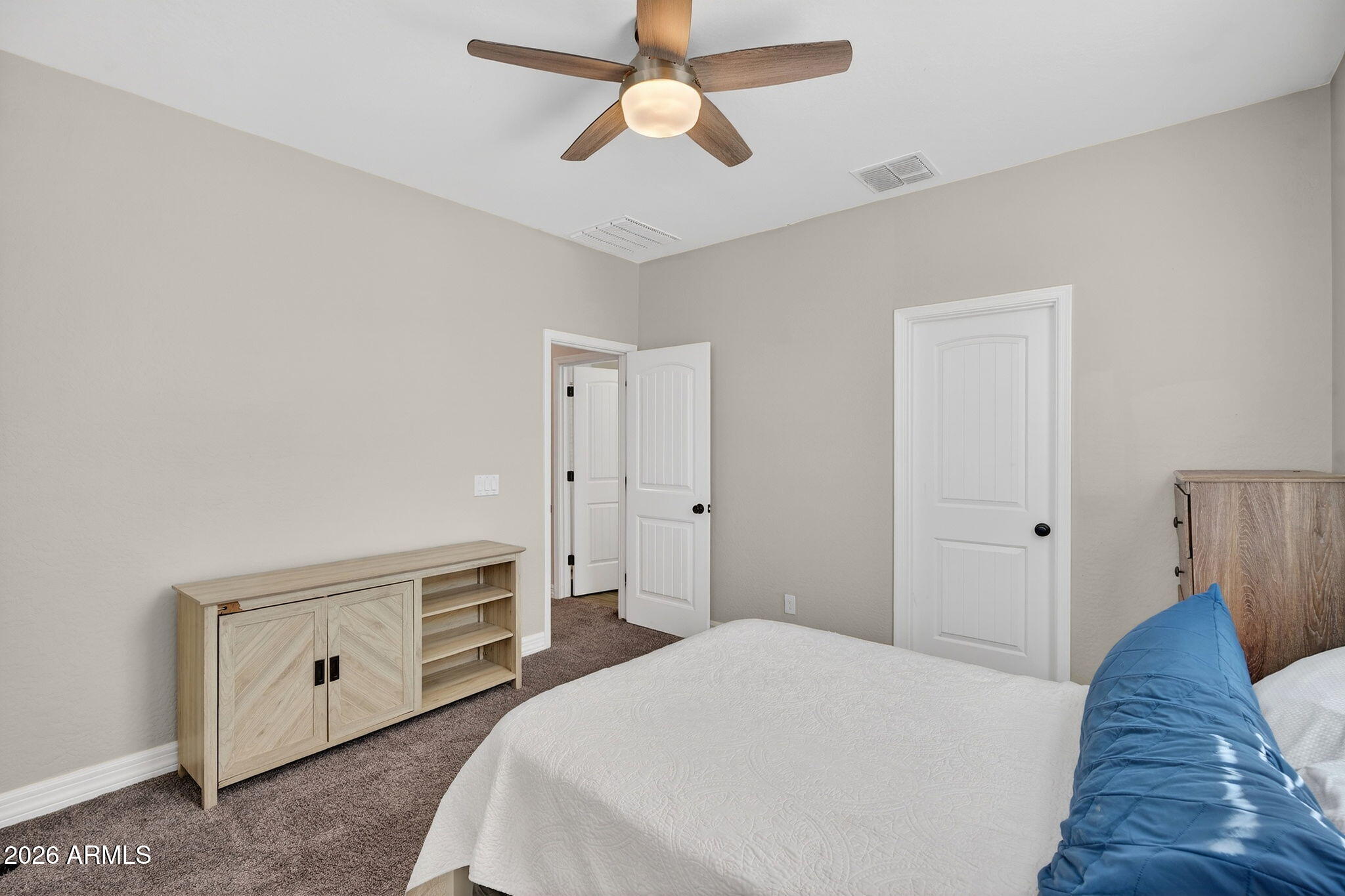 1663 West Gordon Street San Tan Valley, AZ 85144 - Photo 38 of 54 a spacious bedroom with a bed and a chandelier