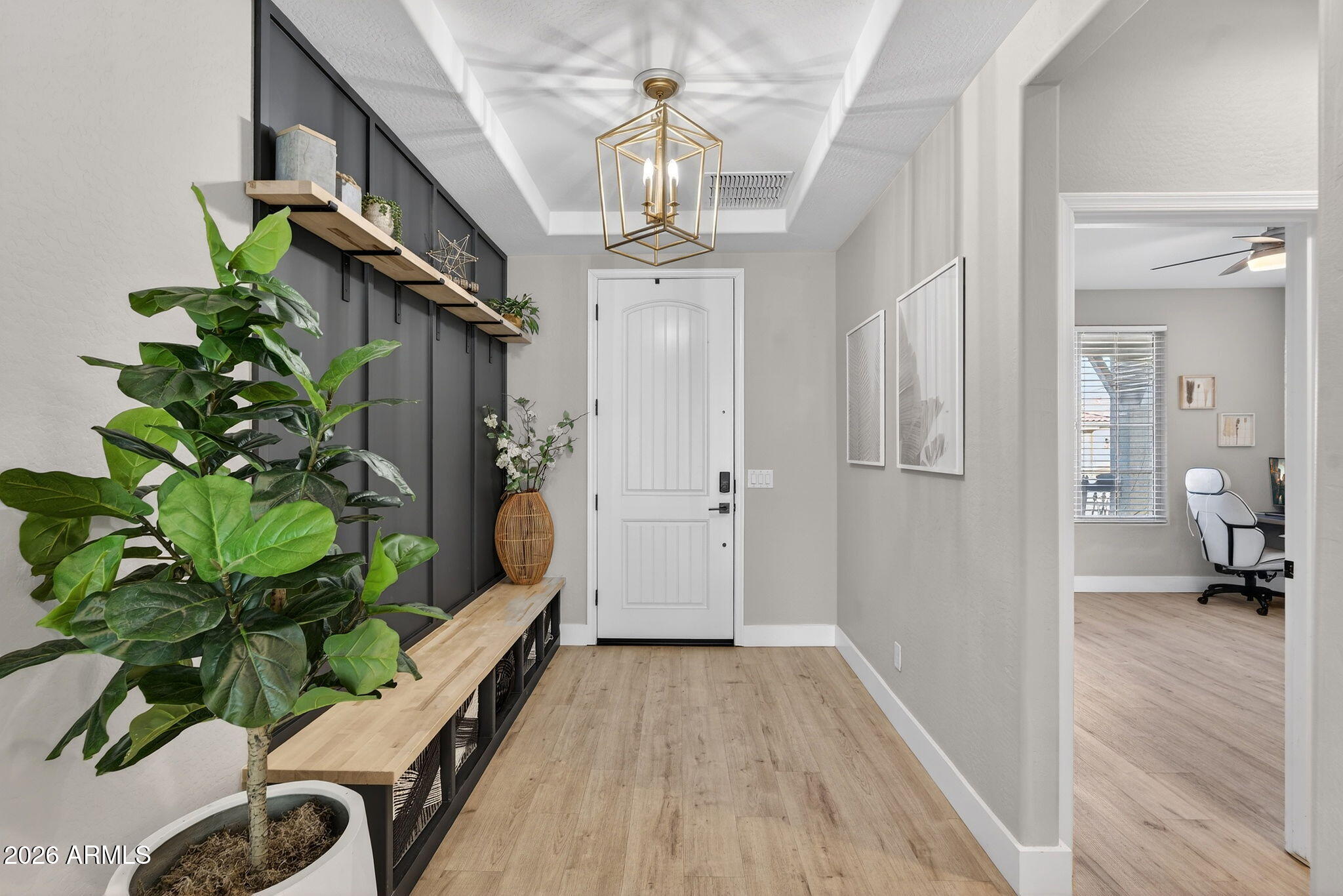 1663 West Gordon Street San Tan Valley, AZ 85144 - Photo 5 of 54 a hallway with wooden floor and chandelier