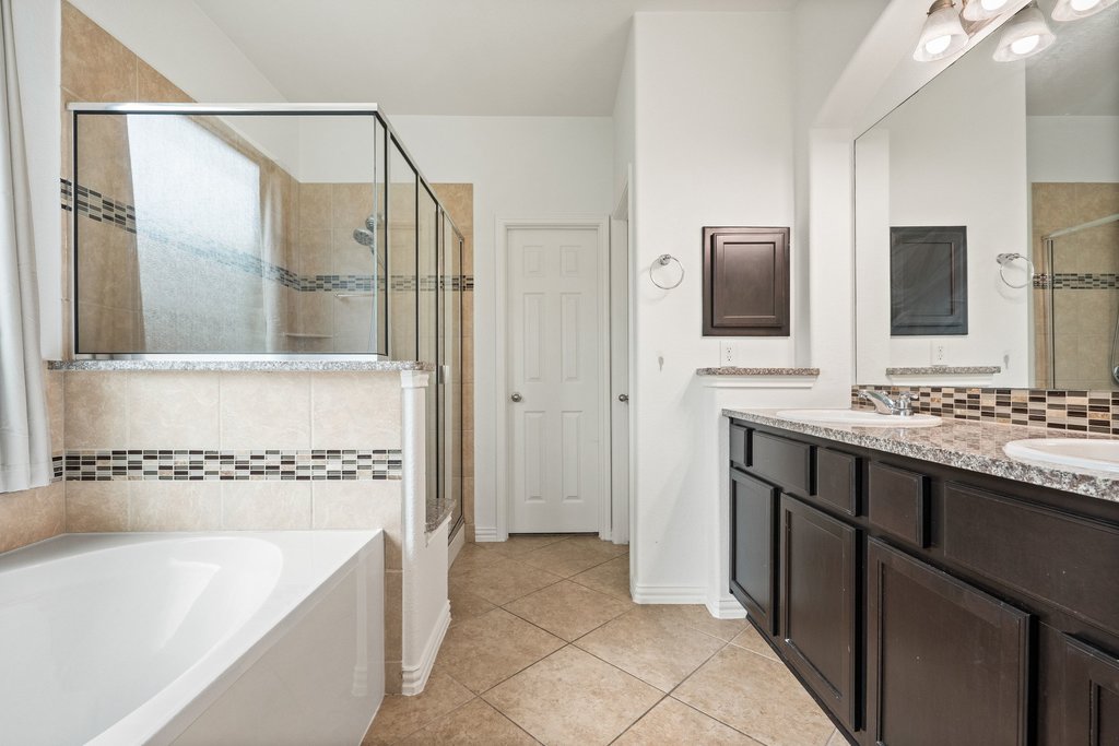 3013 Agave Loop Round Rock, TX 78681 - Photo 16 of 37 Primary Bathroom has a Tub and a Walk in Shower.