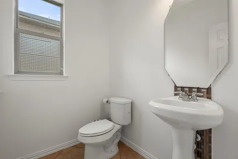 a spacious bathroom with a tub sink and mirror
