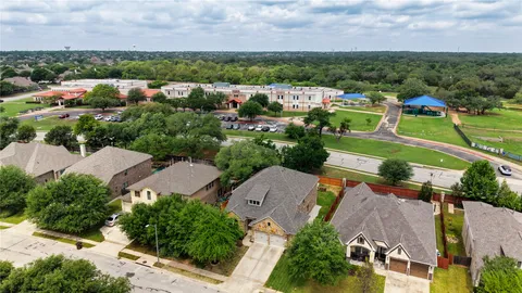an aerial view of a house with a swimming pool