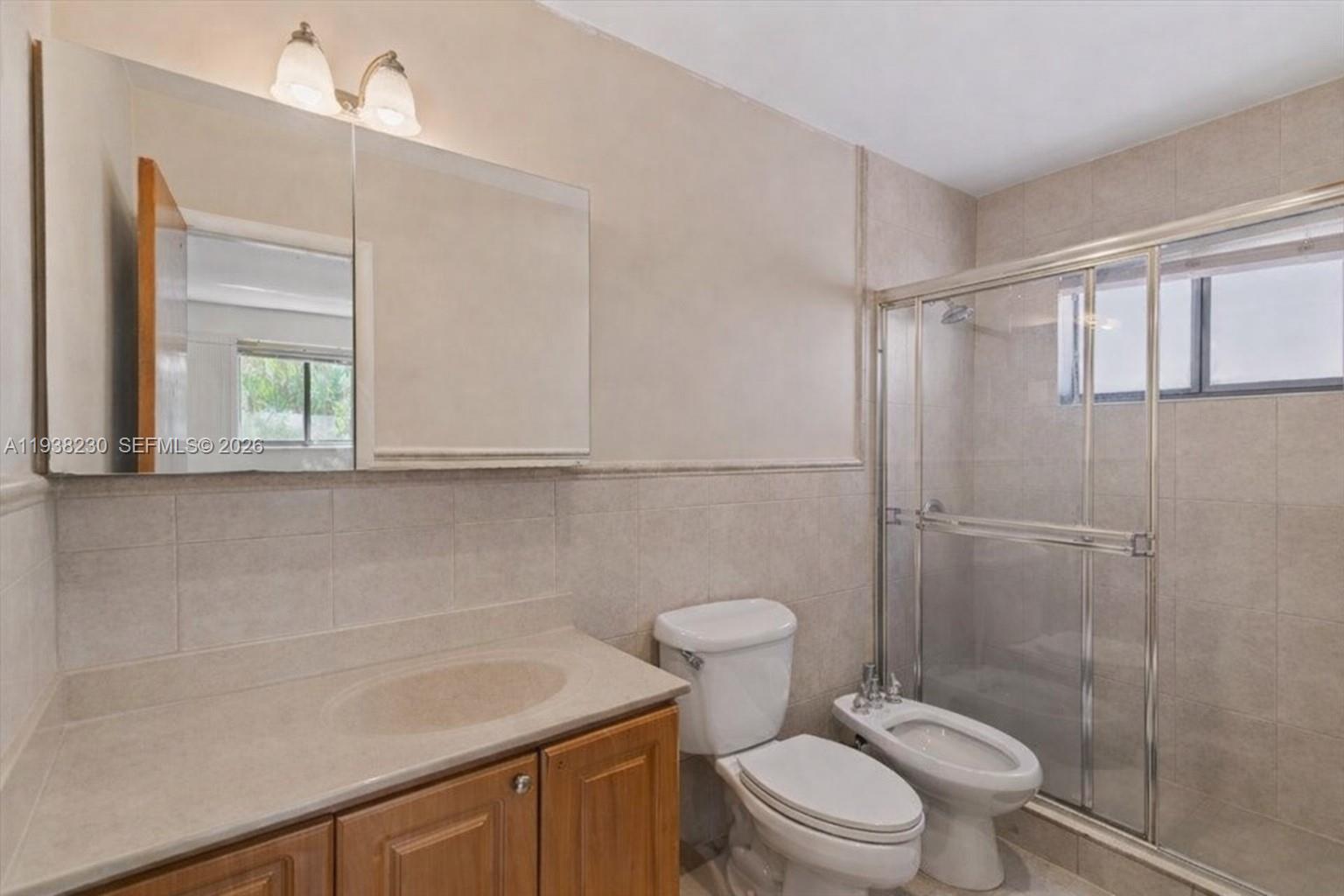 6385 Southwest 25th Street Miami, FL 33155 - Photo 12 of 26 a bathroom with a sink a toilet and shower