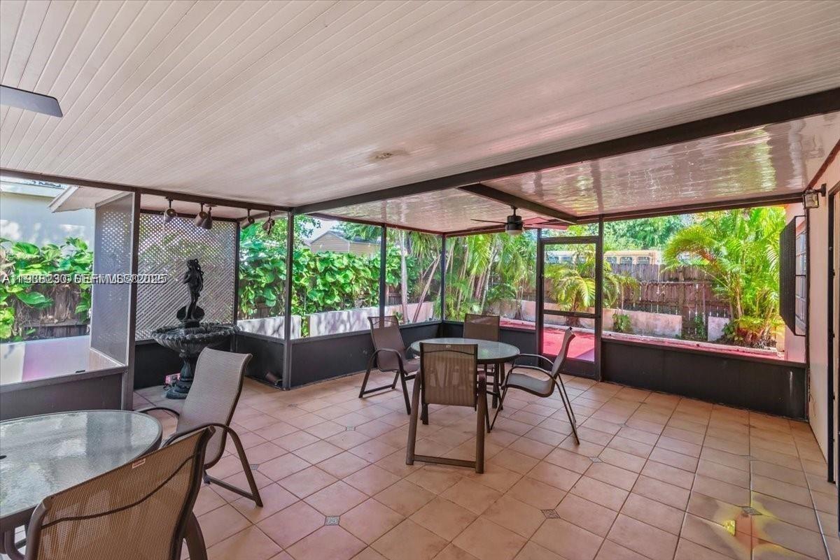 6385 Southwest 25th Street Miami, FL 33155 - Photo 17 of 26 a dining room with furniture and a floor to ceiling window