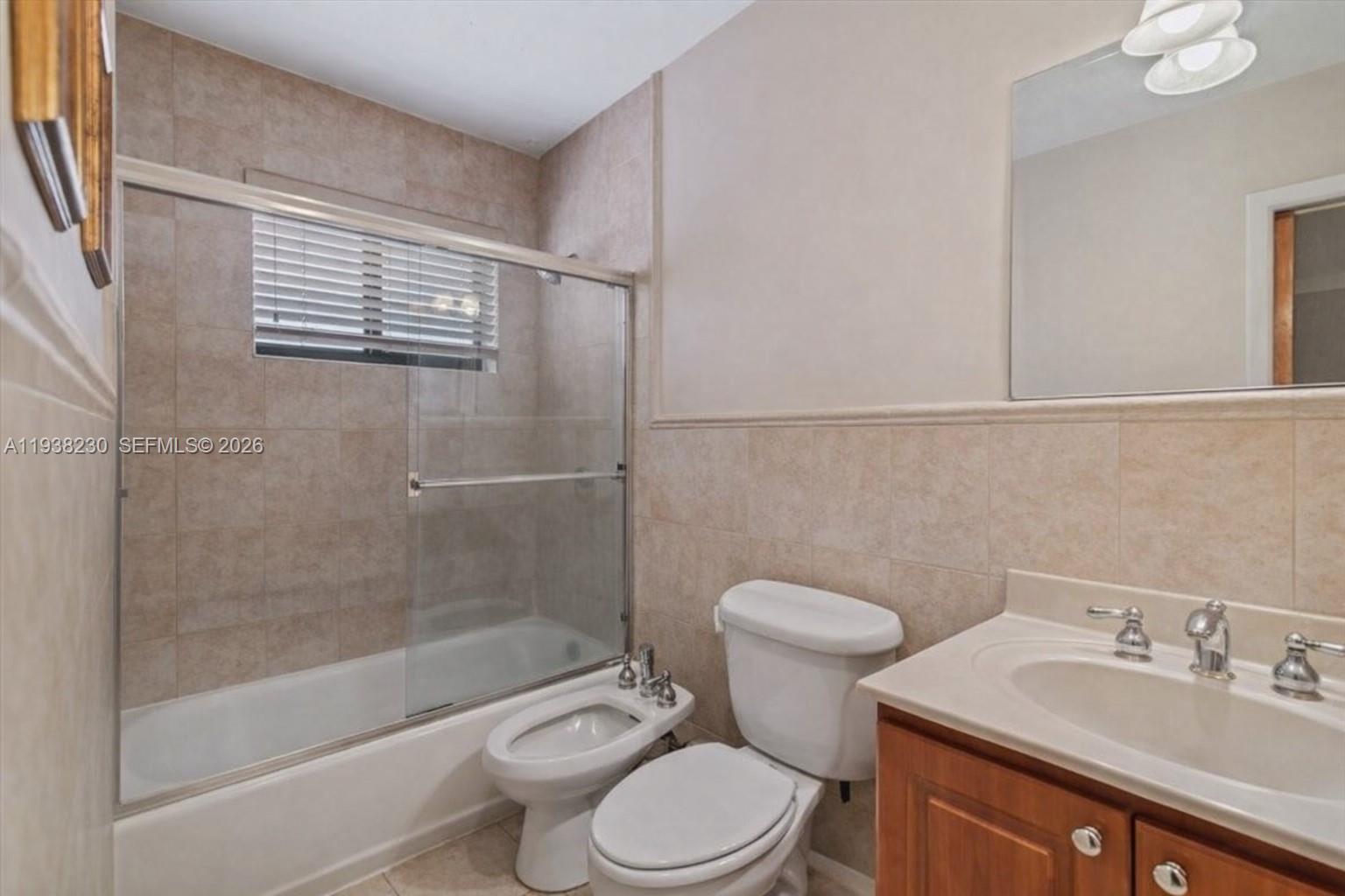 6385 Southwest 25th Street Miami, FL 33155 - Photo 8 of 26 a bathroom with a sink a toilet and shower